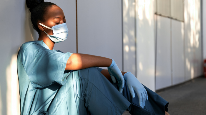 Surgeon sat on the floor exhausted